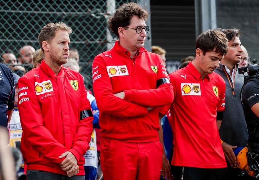 epa07809376 German Formula One driver Sebastian Vettel of Scuderia Ferrari (L), Ferrari team chief Mattia Binotto (C) and Monegasque Formula One driver Charles Leclerc of Scuderia Ferrari attend a min ...
