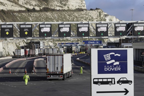 FILE - In this Friday, Dec. 25, 2020 file photo, trucks line up at check-in to the ferry at The Port of Dover, Kent, England. Britain has lifted travel restrictions on truckers that were imposed to av ...