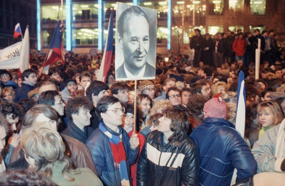 Demonstrators carry a picture of Alexander Dubcek, the leader of the ill-fated Prague Spring, as they march towards Wenceslas Square, Nov. 23, 1989 in Prague for another mass demonstration. More than  ...