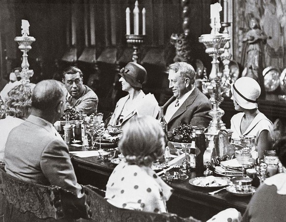 (Original Caption) William Randolph Hearst entertains dinner guests in a hall that had once been the interior of a Spanish Church. (Fair hair, with back to camera, is film star, Marion Davies) Photogr ...