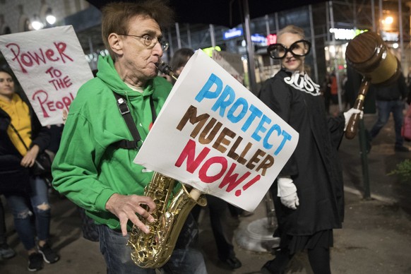 Protesters march through Times Square during a demonstration in support of special counsel Robert Mueller, Thursday, Nov. 8, 2018, in New York. A protest in New York City has drawn several hundred peo ...