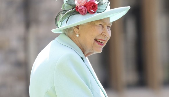 FILE - In this July 17, 2020 file photo, Britain&#039;s Queen Elizabeth smiles after awarding Captain Sir Thomas Moore his knighthood during a ceremony at Windsor Castle in Windsor, England. The forme ...