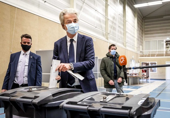 epa09079377 PVV party leader Geert Wilders casts his vote for the parliamentary elections in Sporthal Boswijk, in The Hague, the Netherlands, 17 March 2021. Special measures apply to all polling stati ...