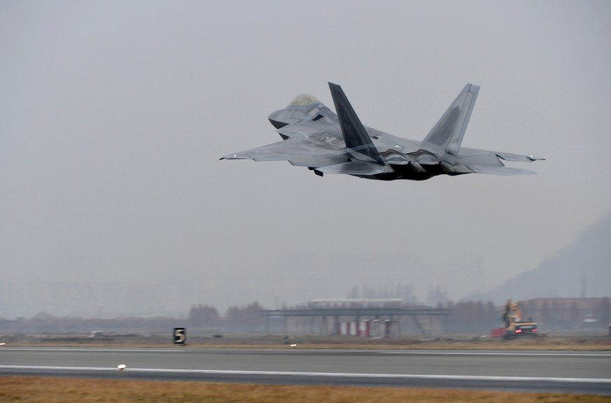 A U.S. Air Force F-22 Raptor takes off from a South Korean air base in Gwangju, South Korea, Monday, Dec. 4, 2017. The United States and South Korea have started their biggest-ever joint air force exe ...