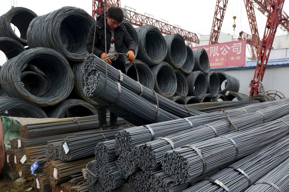 A worker loads steel products onto a vehicle at a steel market in Fuyang in central China&#039;s Anhui province Friday, March 2, 2018. China has expressed &quot;grave concern&quot; about a U.S. trade  ...