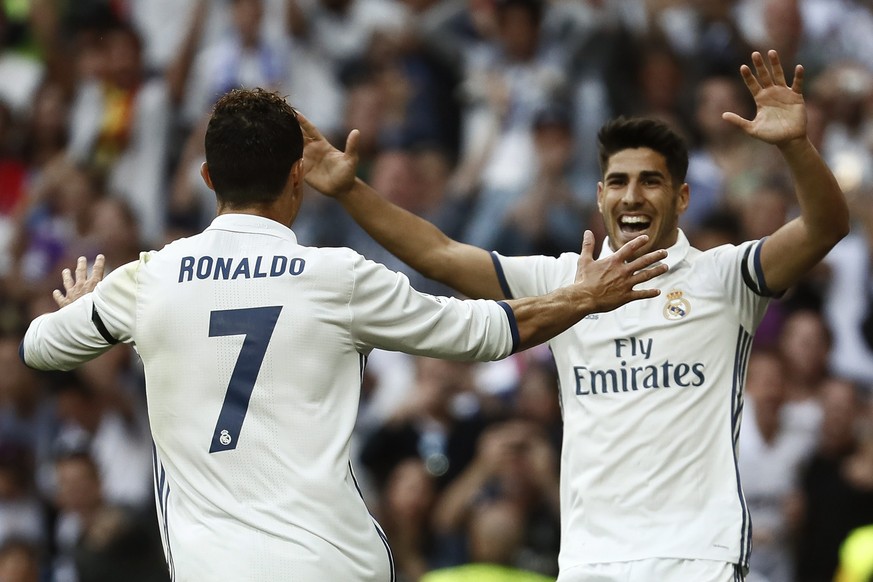 epa05964911 Real Madrid&#039;s Portuguese forward Cristiano Ronaldo (L) celebrates after scoring with team-mate Marco Asensio (R) during the Primera Division Liga match between Real Madrid and Sevilla ...