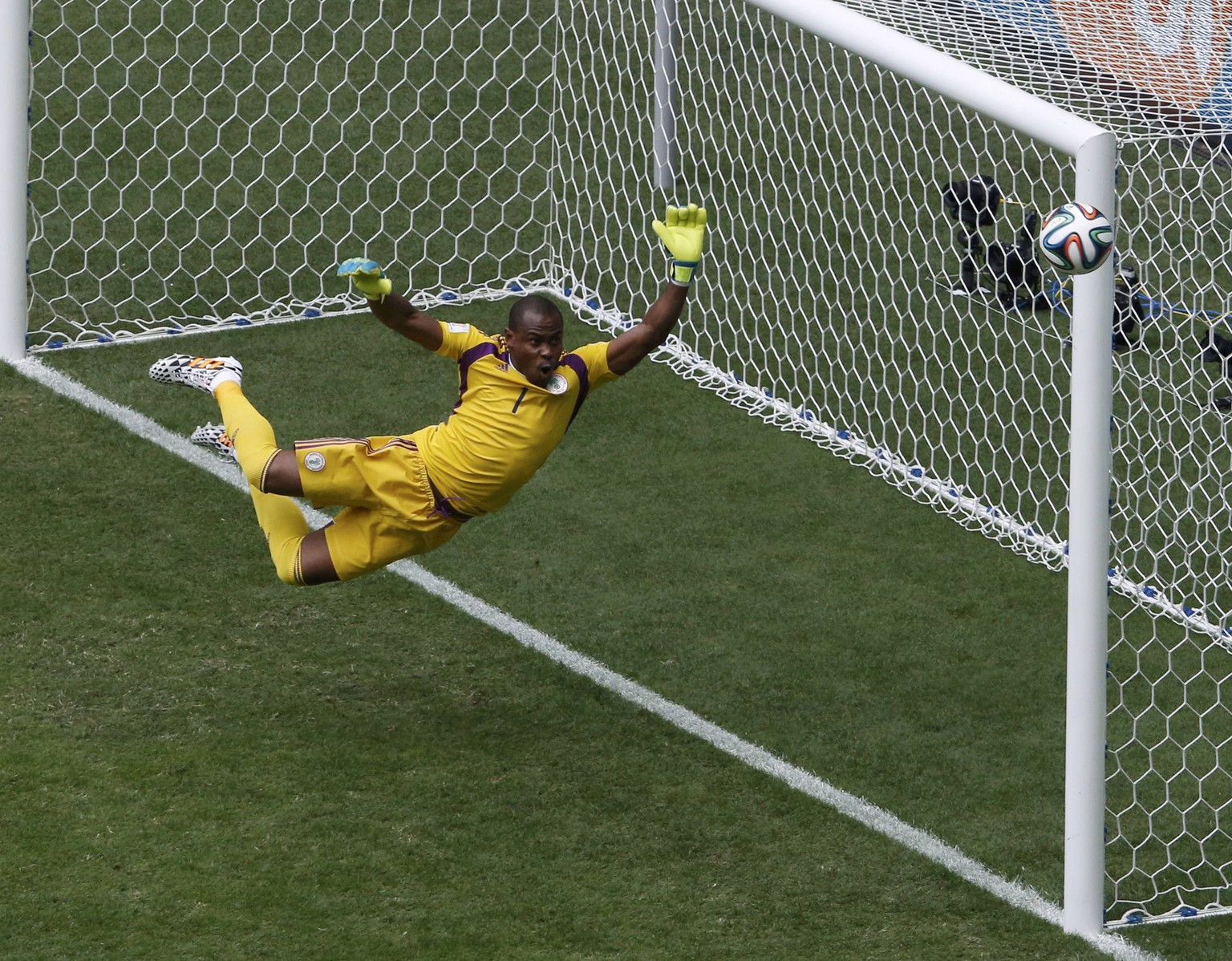 Nigeria&#039;s goalkeeper Vincent Enyeama jumps to make a save on a shot at goal by France&#039;s Paul Pogba (unseen) during their 2014 World Cup round of 16 game at the Brasilia national stadium in B ...