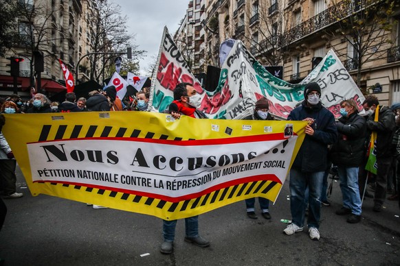 epa08864755 Protesters gather against France&#039;s controversial global security law, during a protest in a street between Porte des Lilas and Gambetta square, in Paris, France, 05 December 2020. The ...