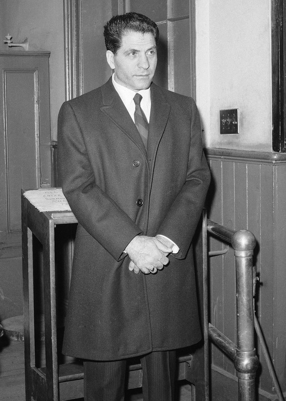 FILE - In this March 24, 1966, file photo, John &quot;Sonny&quot; Franzese waits to be booked at the Elizabeth Street police station in New York, after his arrest on a 43-count gambling indictment. Fr ...