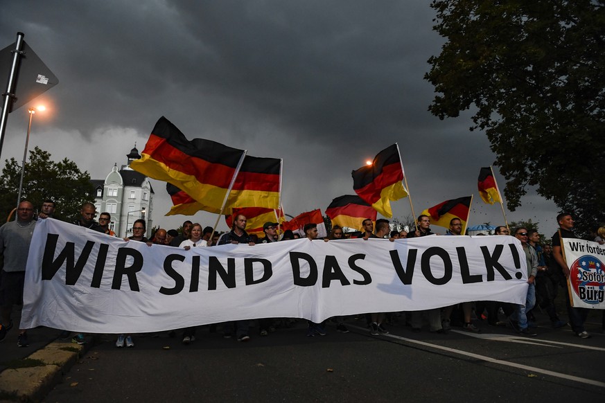 epa07003732 Protesters display a banner reading &#039;Wir sind das Volk!&#039; (We are the people!) during a rally of right-wing populist movement &#039;pro Chemnitz&#039; in central Chemnitz, Germany ...