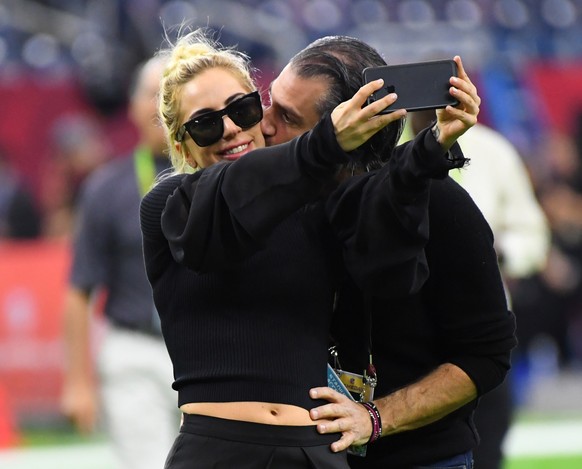 Feb 5, 2017; Houston, TX, USA; Recording artist Lady Gaga gets a kiss from Christian Carino before Super Bowl LI between the Atlanta Falcons and the New England Patriots at NRG Stadium. Mandatory Cred ...