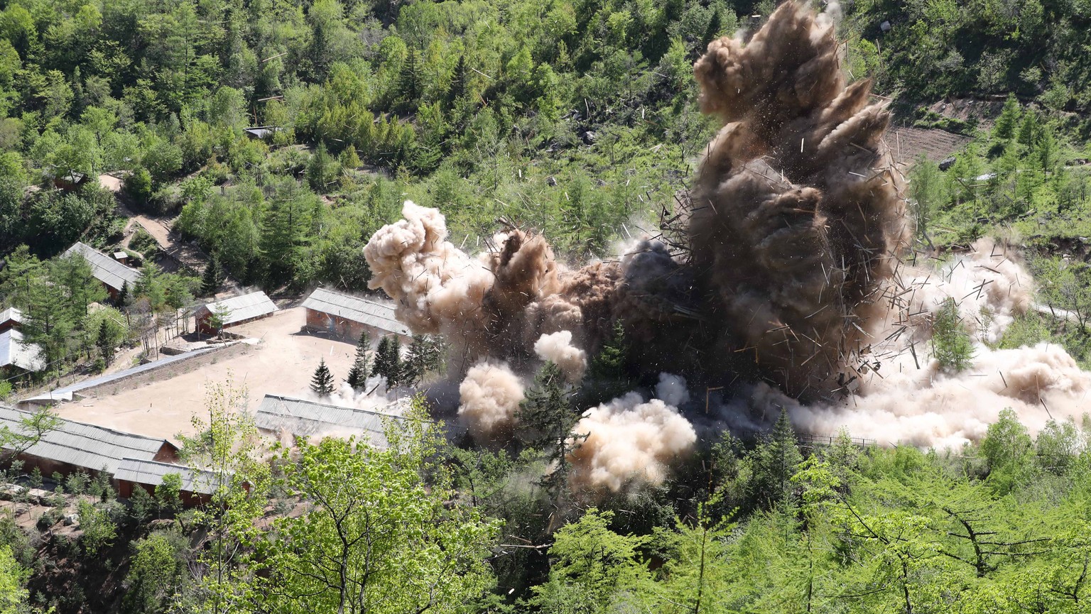epa06761540 Earth is displaced during an explosion on the first day of dismantling at North Korea&#039;s Punggye-ri nuclear test site in Punggye-ri, North Korea, 24 May 2018 (issued 25 May 2018). On 2 ...