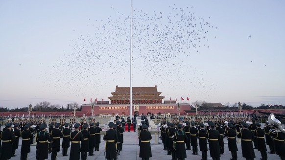 In this photo provided by Xinhua News Agency, the Guard of Honor of the Chinese People&#039;s Liberation Army (PLA) perform the national flag-raising duty on Tian&#039;anmen Square in Beijing, China,  ...