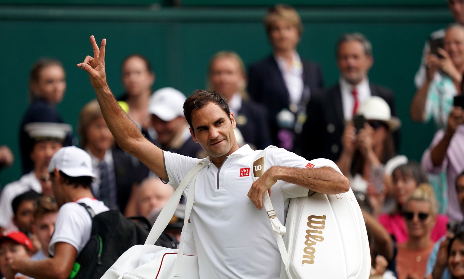epa07699688 Roger Federer of Switzerland celebrates winning against Lucas Pouille of France in their third round match during the Wimbledon Championships at the All England Lawn Tennis Club, in London ...
