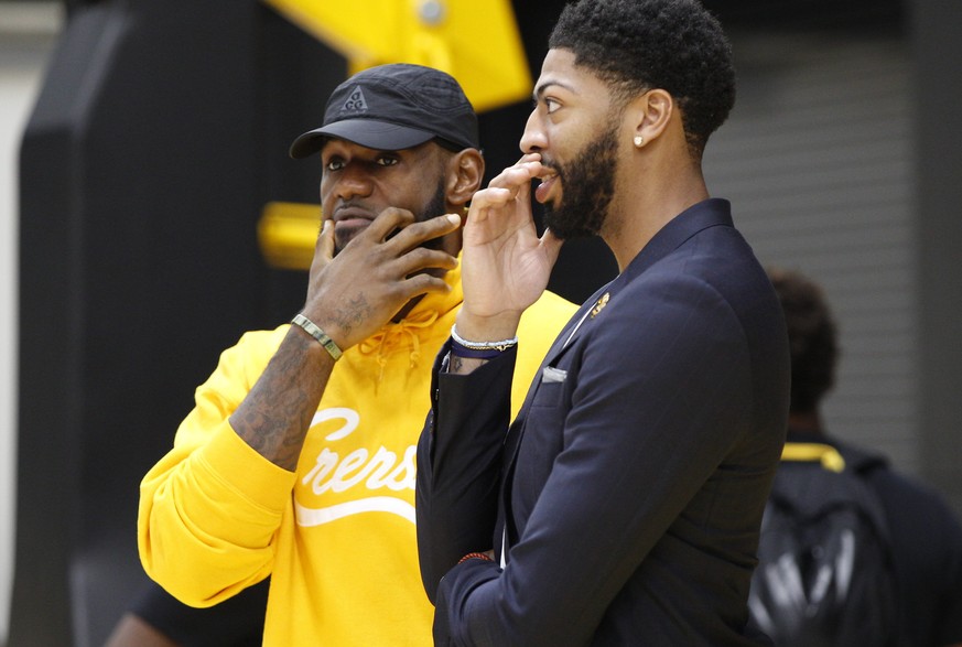 Los Angeles Lakers NBA basketball players, LeBron James, left, and Anthony Davis share a moment after David was introduced at a news conference at the UCLA Health Training Center in El Segundo, Calif. ...