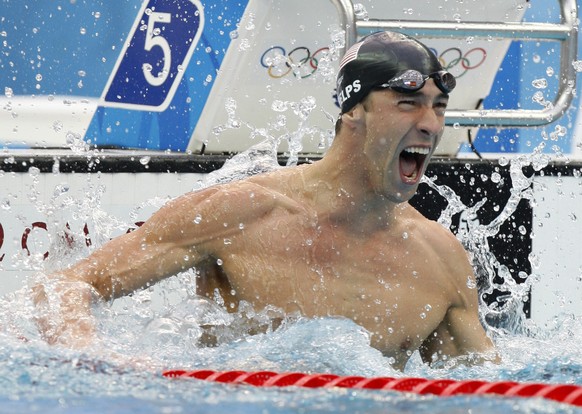 FILE - In this Aug. 16, 2008 file photo, United States&#039; Michael Phelps reacts as he wins gold in the final of the men&#039;s 100-meter freestyle during the swimming competitions in the National A ...