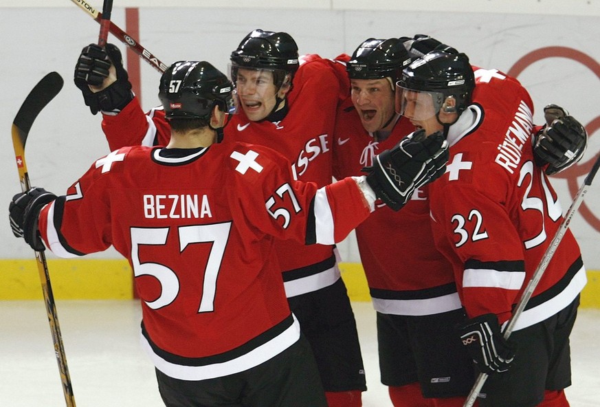 Swiss Goran Bezina, Martin Pluess, Paul di Pietro and Ivo Ruethemann, from left, celebrate di Pietros second goal, during their men&#039;s preliminary round group A ice hockey match Canada against Swi ...