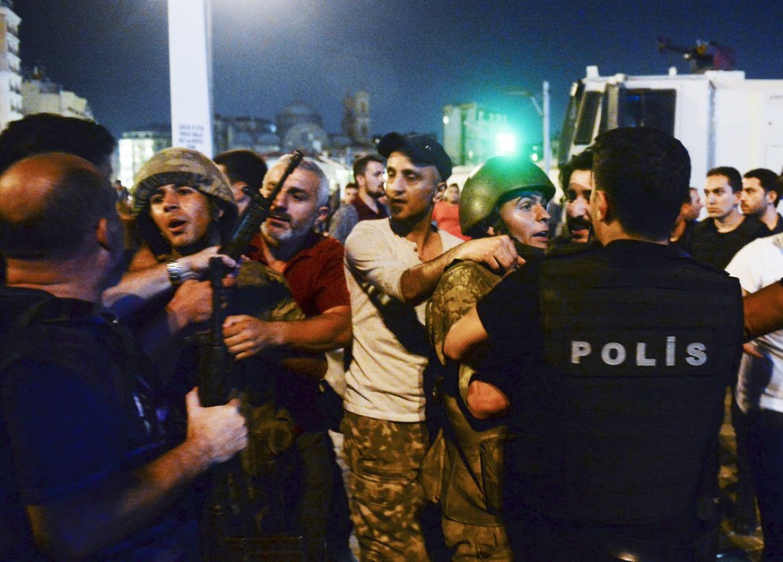 Turkish soldiers, arrested by civilians, are handed to police officers, in Istanbul&#039;s Taksim square, early Saturday, July 16, 2016. Members of Turkey&#039;s armed forces said they had taken contr ...