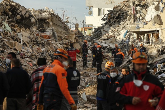 Members of rescue services work at collapsed buildings, destroyed in the Oct. 30 earthquake in Izmir, Turkey, Tuesday, Nov. 3, 2020. Rescuers in the Turkish coastal city pulled a young girl out alive  ...