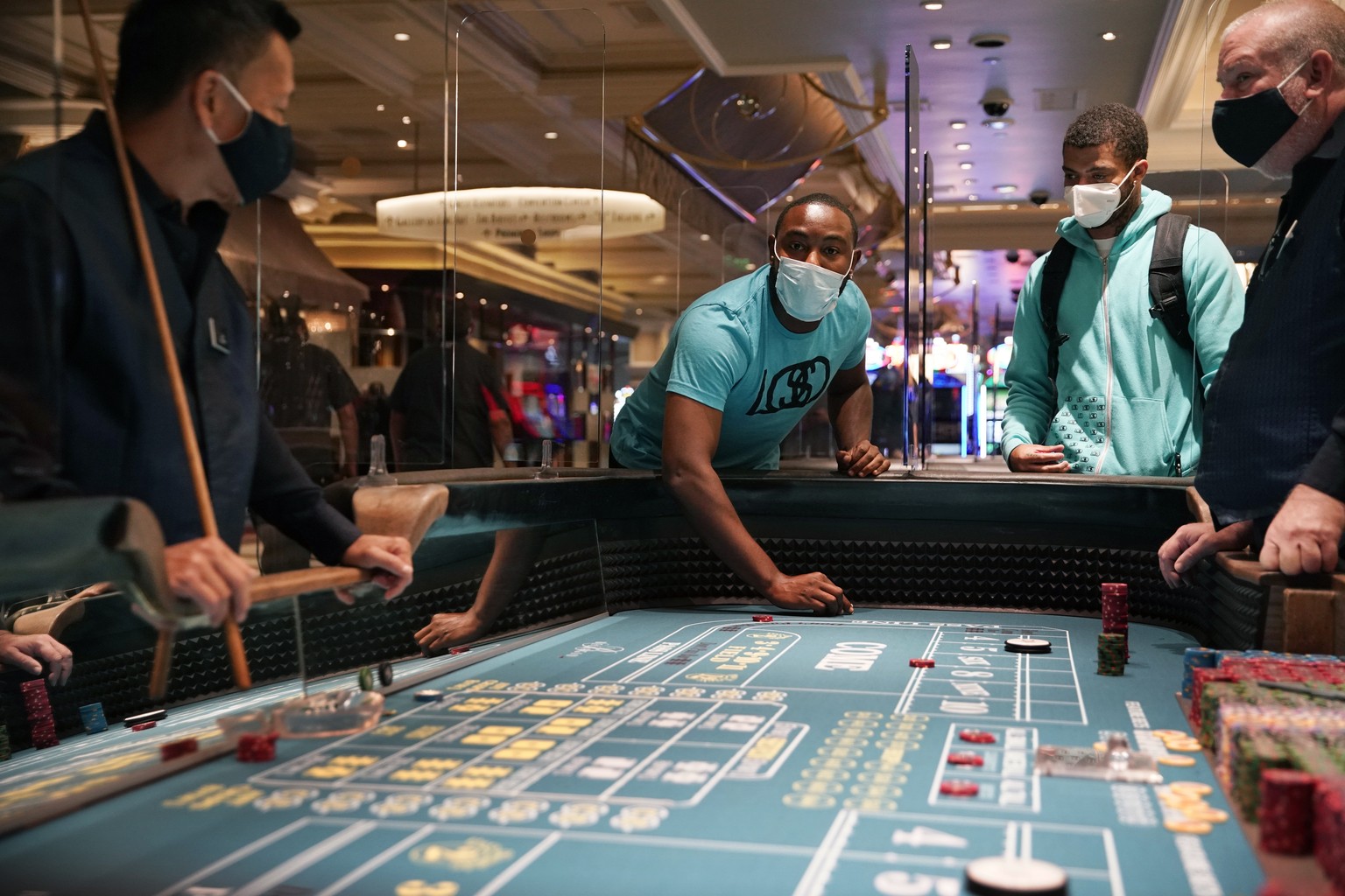 People play craps after the reopening of the Bellagio hotel and casino Thursday, June 4, 2020, in Las Vegas. Casinos in Nevada were allowed to reopen on Thursday for the first time after temporary clo ...