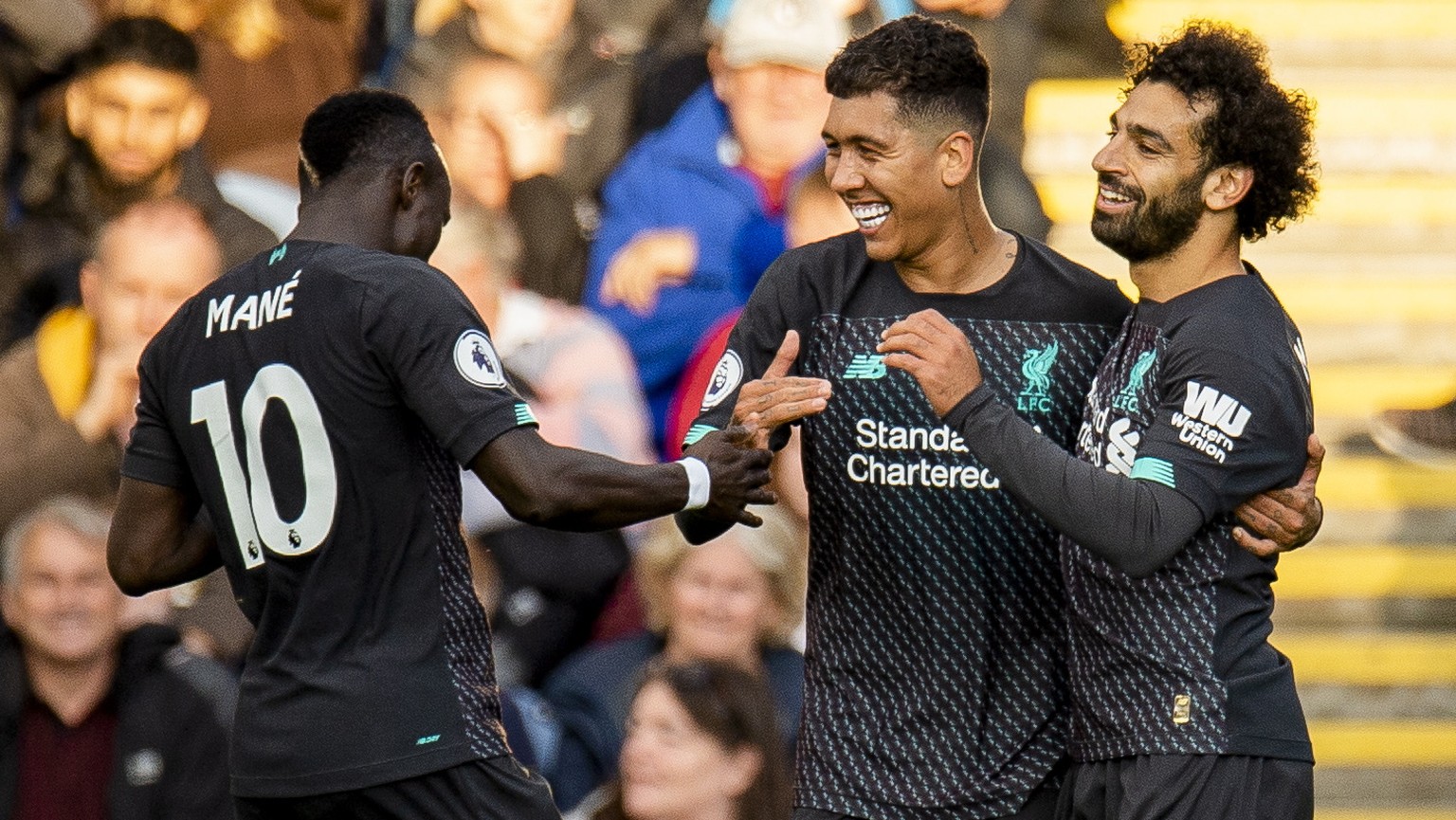 epa07808226 Liverpool&#039;s Roberto Firmino celebrates scoring the third goal with Mohamed Salah (R) and Sadio Mane (L) during the English Premier League soccer match between Burnley and Liverpool he ...