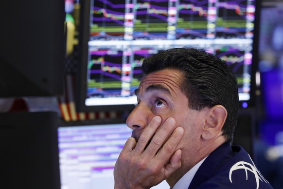 FILE - In this Aug. 12, 2019, photo specialist Peter Mazza works at his post on the floor of the New York Stock Exchange. Stocks of companies that do lots of business with China are obvious targets to ...