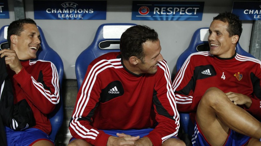 Basel&#039;s Marco Streller, center, sits on the bench between Philipp Degen, right, and David Degen, left, during a Champions League play-off second leg match between Switzerland&#039;s FC Basel 1893 ...