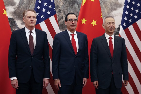 Chinese Vice Premier Liu He, right, poses with U.S. Treasury Secretary Steven Mnuchin, center, and U.S. Trade Representative Robert Lighthizer, left, before they proceed to their meeting at the Diaoyu ...