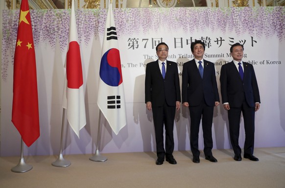 Chinese Premier Li Keqiang, left, Japanese Prime Minister Shinzo Abe, center, and South Korean President Moon Jae-in, right, pose for photographers prior to their summit in Tokyo Wednesday, May 9, 201 ...