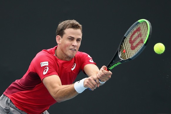epa08156942 Vasek Pospisil of Canada in action during his doubles match against Neal Skupski of United Kingdom and Jamie Murray of United Kingdom on day five of the Australian Open tennis tournament a ...