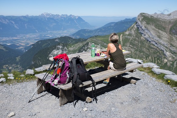 Nicole A. enjoys the view from a Terrace of the Cabane de Plan Neve on the plain of Chablais and the Geneva Lake, above Les Plans-sur-Bex, Switzerland, this Tuesday, June 26, 2018. The Cabane de Plan  ...