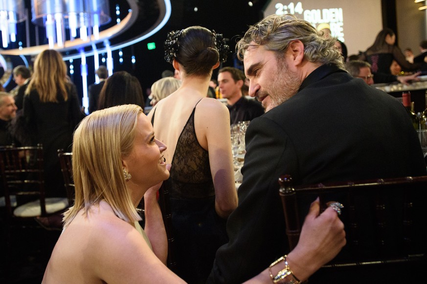 epa08106845 A handout photo made available by the Hollywood Foreign Press Association (HFPA) shows Reese Witherspoon and Joaquin Phoenix during the 77th annual Golden Globe Awards ceremony at the Beve ...