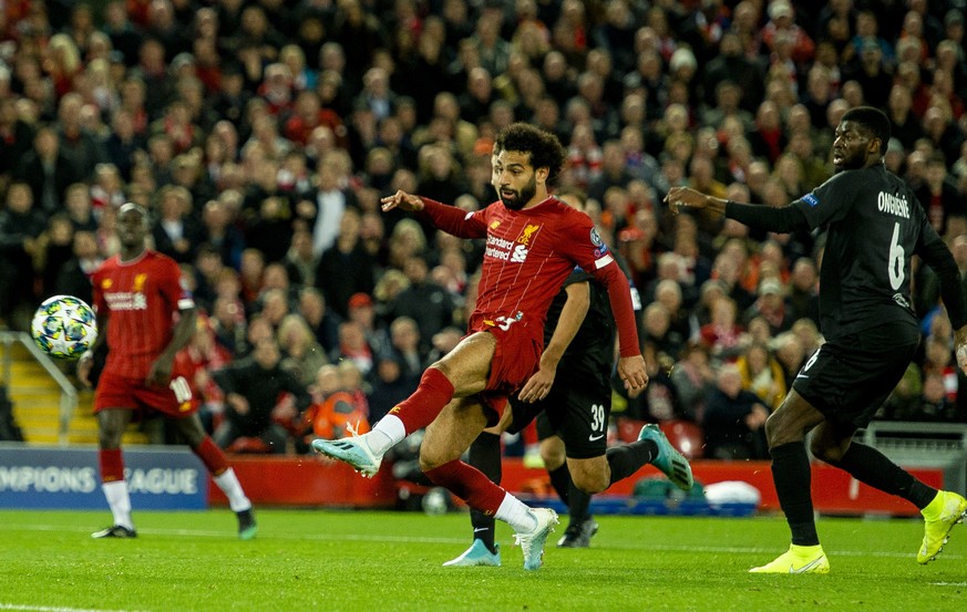 epa07890501 Liverpool&#039;s Mohamed Salah (C) scores the 4-3 goal during the UEFA Champions League Group E soccer match between Liverpool FC and FC Salzburg held at the Anfield in Liverpool, Britain, ...