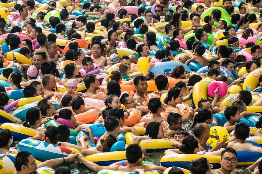 epa06105232 Chinese tourists with swim rings enjoy swimming in the lake called &#039;Dead sea of China&#039; in a resort of Suining city, southwestern China&#039;s Sichuan province, 22 July 2017. More ...