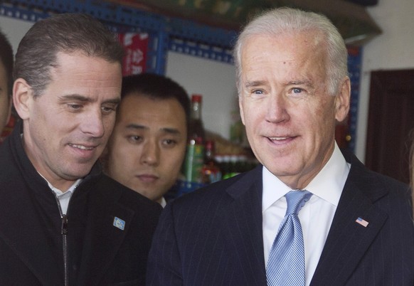 epa07872759 (FILE) - Then US Vice President Joe Biden (R) tours a Hutong alley with his son Hunter Biden (L) in Beijing, China, 05 December 2013 (reissued 27 September 2019). An impeachment inquiry ag ...