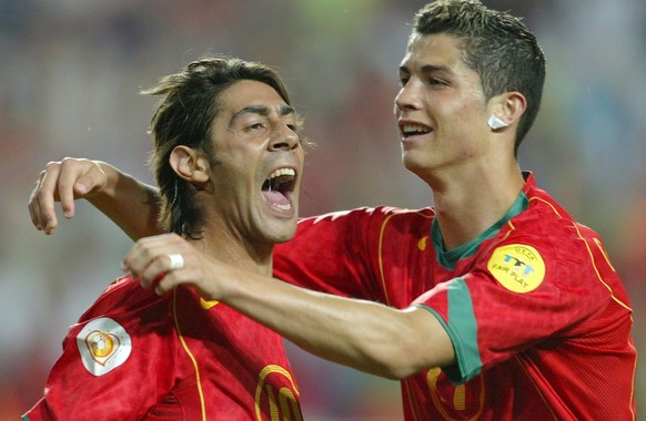 Portuguese midfielder Rui Costa (L) celebrates with his team mate Cristiano Ronaldo (R) after scoring his team&#039;s second goal against Russia during their Group A soccer match as part of the Europe ...