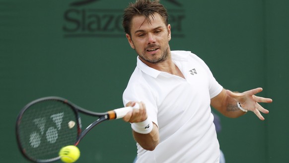epa06864258 Stan Wawrinka of Switzerland returns to Thomas Fabbiano of Italy in their second round match during the Wimbledon Championships at the All England Lawn Tennis Club, in London, Britain, 04  ...