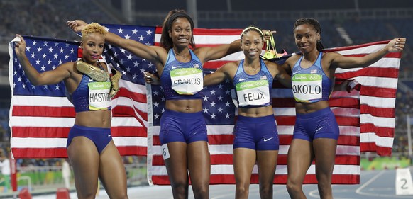 The United States team from left, Natasha Hastings, Phyllis Francis, Allyson Felix and Courtney Okolo celebrate winning the gold medal in the women&#039;s 4x400-meter relay final during the athletics  ...