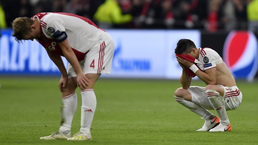 Ajax players react at the end of the Champions League semifinal second leg soccer match between Ajax and Tottenham Hotspur at the Johan Cruyff ArenA in Amsterdam, Netherlands, Wednesday, May 8, 2019.  ...