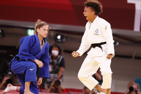 epa09363863 Amandine Buchard of France (white) reacts after her win against Fabienne Kocher of Switzerland (blue) during their bout in the Women&#039;s -52kg Semifinal of Table A Judo events of the To ...