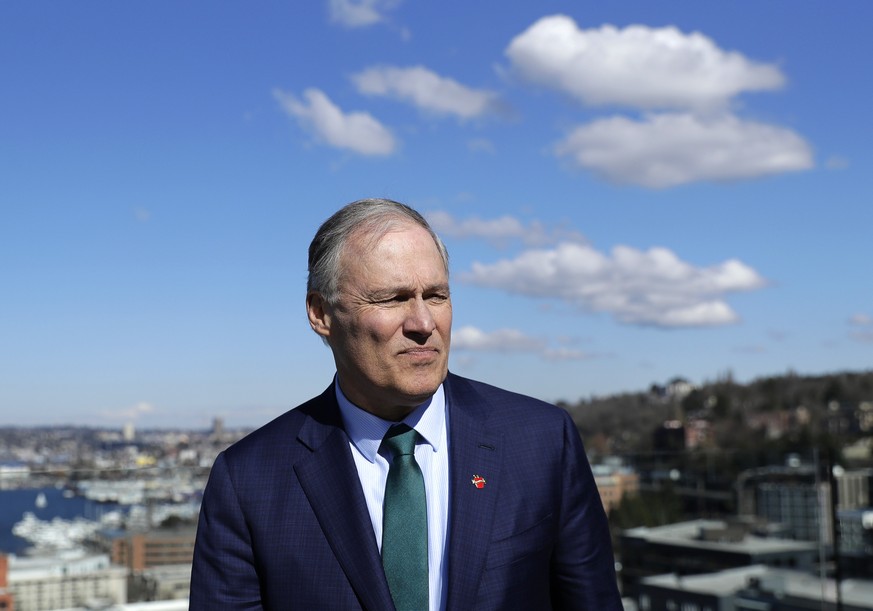 In this March 1, 2019 photo, Washington Gov. Jay Inslee stands on an outdoor patio as he takes part in media interviews in Seattle after announcing earlier in the day that he will seek the 2020 Democr ...