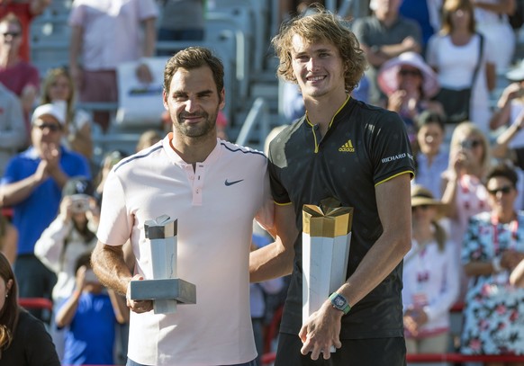 Winner Alexander Zverev, right, of Germany, poses for a photo with his opponent Roger Federer, of Switzerland, during victory ceremonies at the Rogers Cup tennis tournament in Montreal, Sunday, Aug. 1 ...