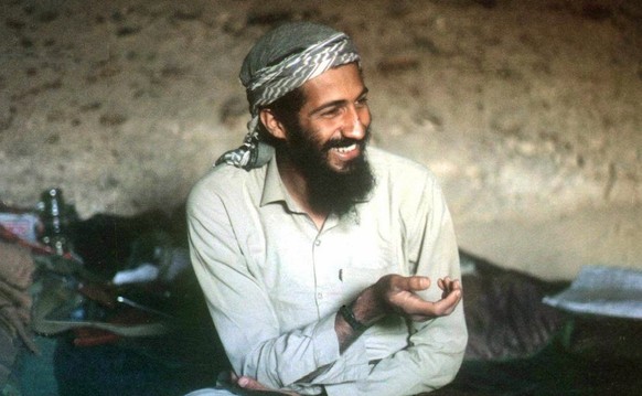 Saudi-born billionaire Osama Bin Laden smiles as he sits in a cave in the Jalalabad region of Afghanistan in this 1988 photo. A CIA-led operation has killed Osama bin Laden in Pakistan and recovered h ...