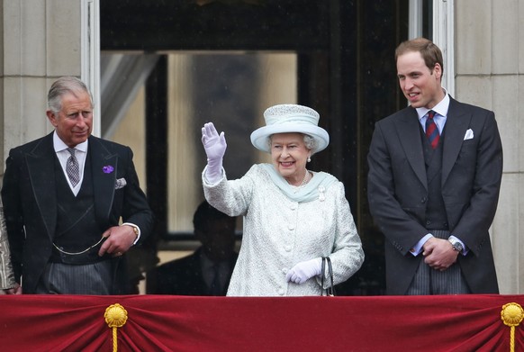 FILE - In this June 5, 2012 file photo, Queen Elizabeth II, center, accompanied by Prince Charles, left, and Prince William, appear on the balcony of Buckingham Palace in central London, to conclude t ...