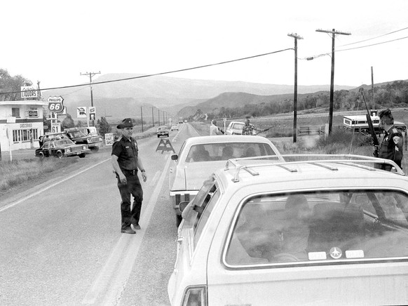 Police inspect a vehicle at a roadblock near Glenwood Springs, Colo., June 1977. Suspected serial killer Ted Bundy escaped from the Pitkin County Courthouse on June 7 and is the subject of a manhunt.  ...