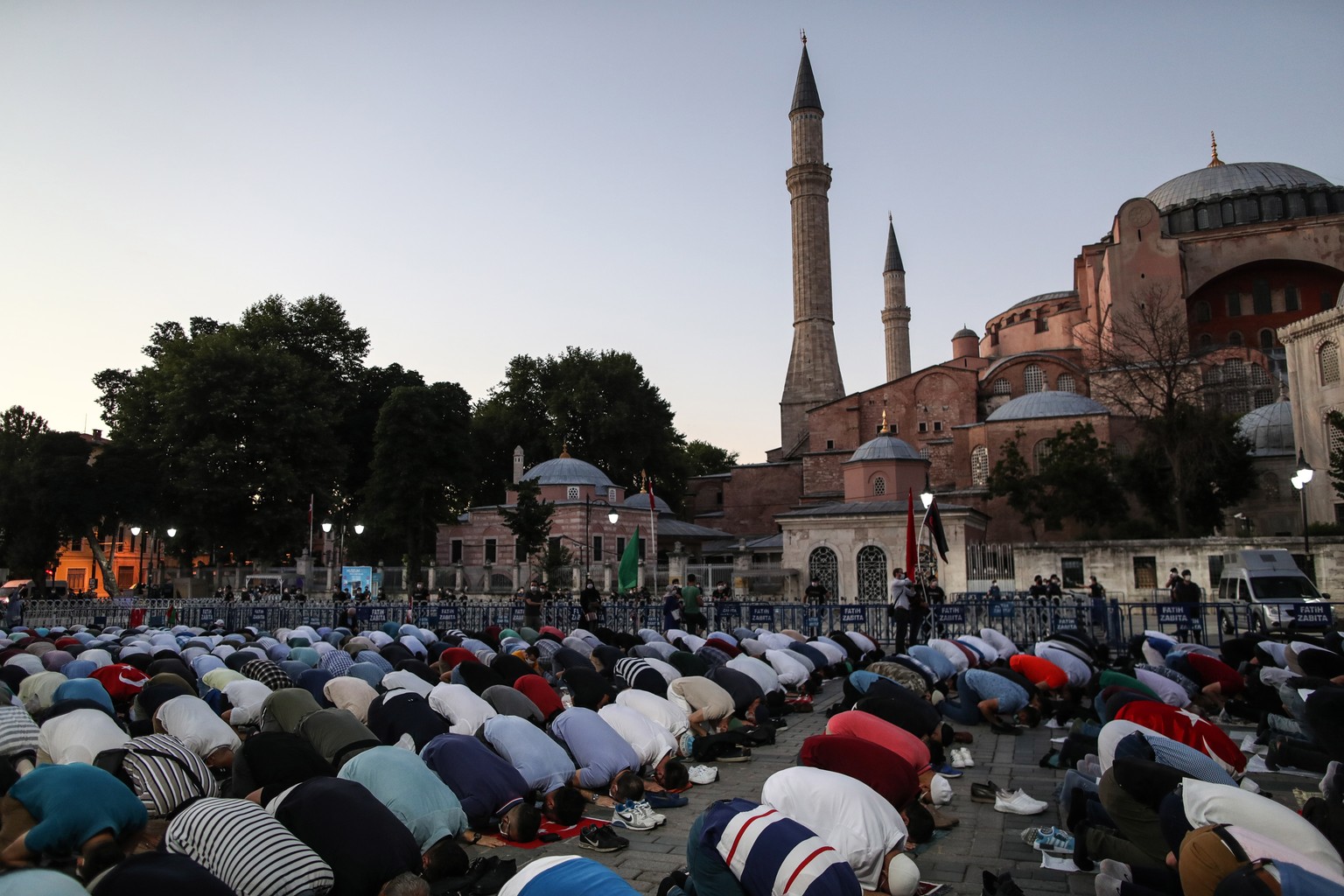 epa08539325 Supporters of president Erdogan pray as they celebrate Turkey&#039;s decision that the 1,500 year old Unesco World Heritage site Hagia Sophia can be converted into a mosque in front of the ...