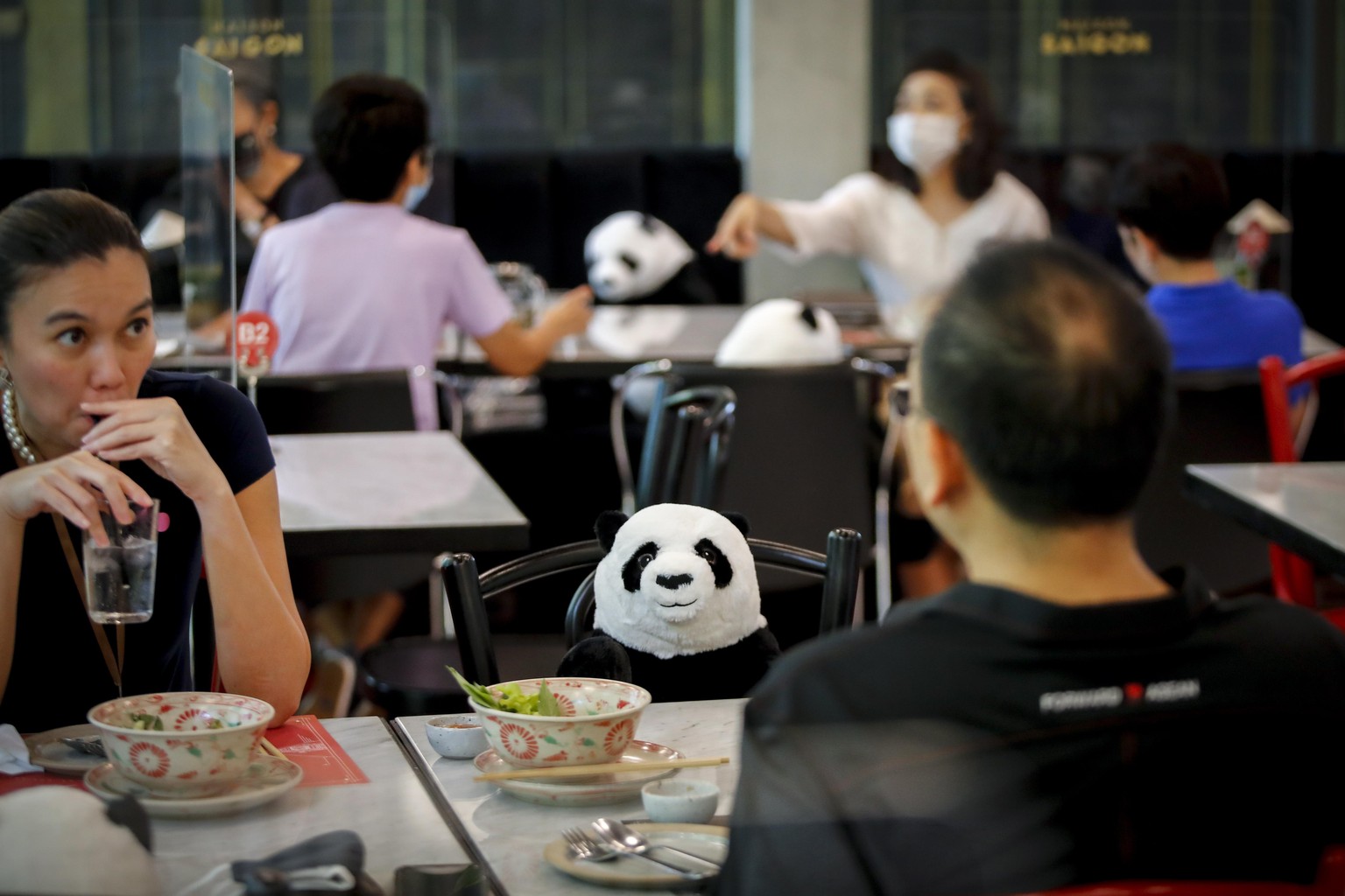 epa08431222 A stuffed panda is placed on a chair as a means to enforce social distancing at a restaurant in Bangkok, Thailand, 19 May 2020. Thailand has relaxed stringent lockdown measures allowing ce ...