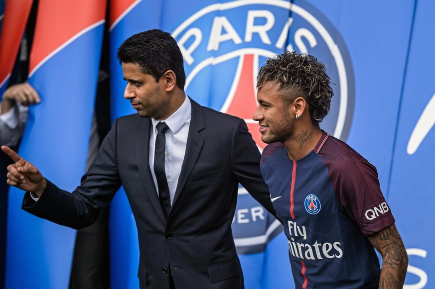 epa06124323 Paris Saint Germain&#039;s chairman and CEO Nasser Al-Khelaif (L) and Brazilian striker Neymar Jr (R) pose for photographs with his new PSG jersey after a press conference at the Parc des  ...