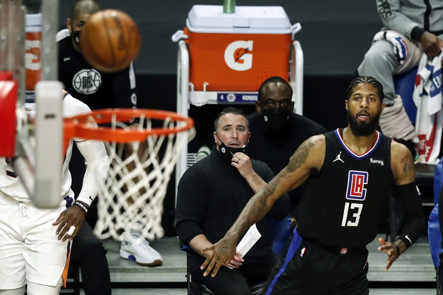 epa09123464 LA Clippers forward Paul George (R) scores during the NBA game between the Phoenix Suns and the Los Angeles Clippers at the Staples Center in Los Angeles, California, USA, 08 April 2021. E ...