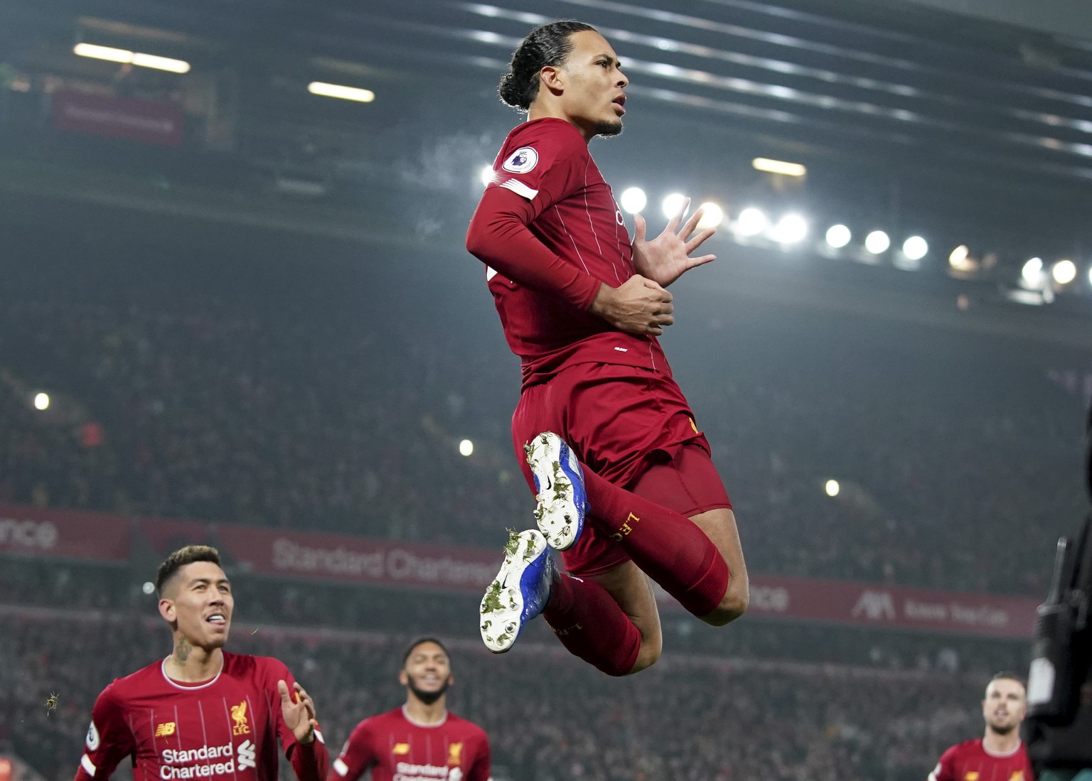 Liverpool&#039;s Virgil van Dijk jumps to celebrate scoring his side&#039;s first goal during the English Premier League soccer match between Liverpool and Manchester United at Anfield Stadium in Live ...